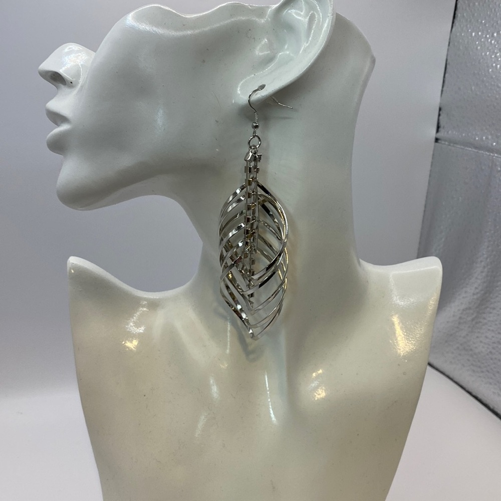 Stunning multi layered silver tone earrings faux diamond center.